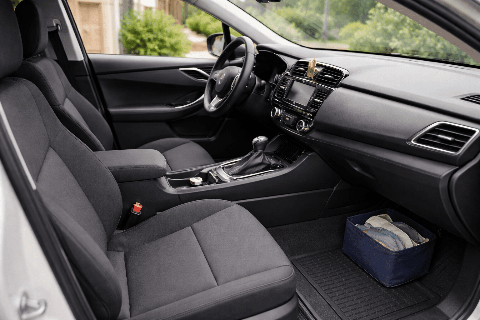 Spotlessly clean car interior with wiped dashboard, vacuumed seats, and a small organized console tray in bright natural light