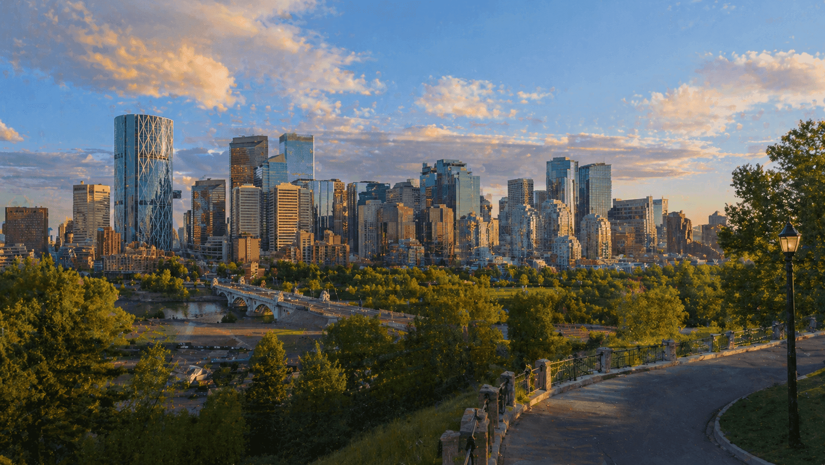 The Calgary skyline viewed from the ridge of Crescent Road NW in the Rosedale neighborhood, with the Bow River valley visible below.