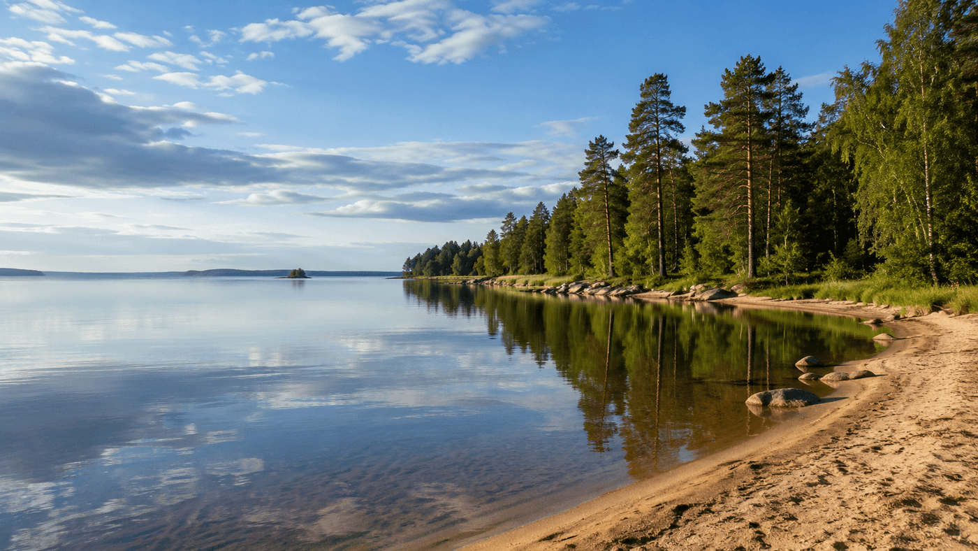 Lake Vänern in western Sweden, Europe's largest lake, with its sandy shoreline and forested banks reflected in calm water under a Nordic sky.