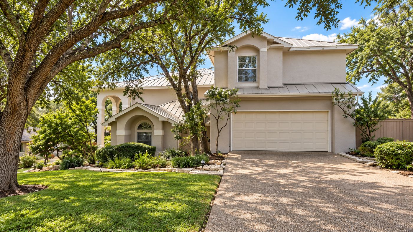 Beige exterior of a San Antonio home with a teal, pink, and cyan 80s-style interior